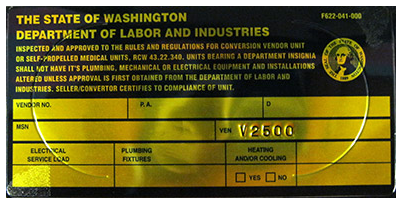 Etiqueta amarilla del Departamento de Trabajo e Industrias del Estado de Washington que indica que la unidad convertida ha sido aprobada tras la inspección.